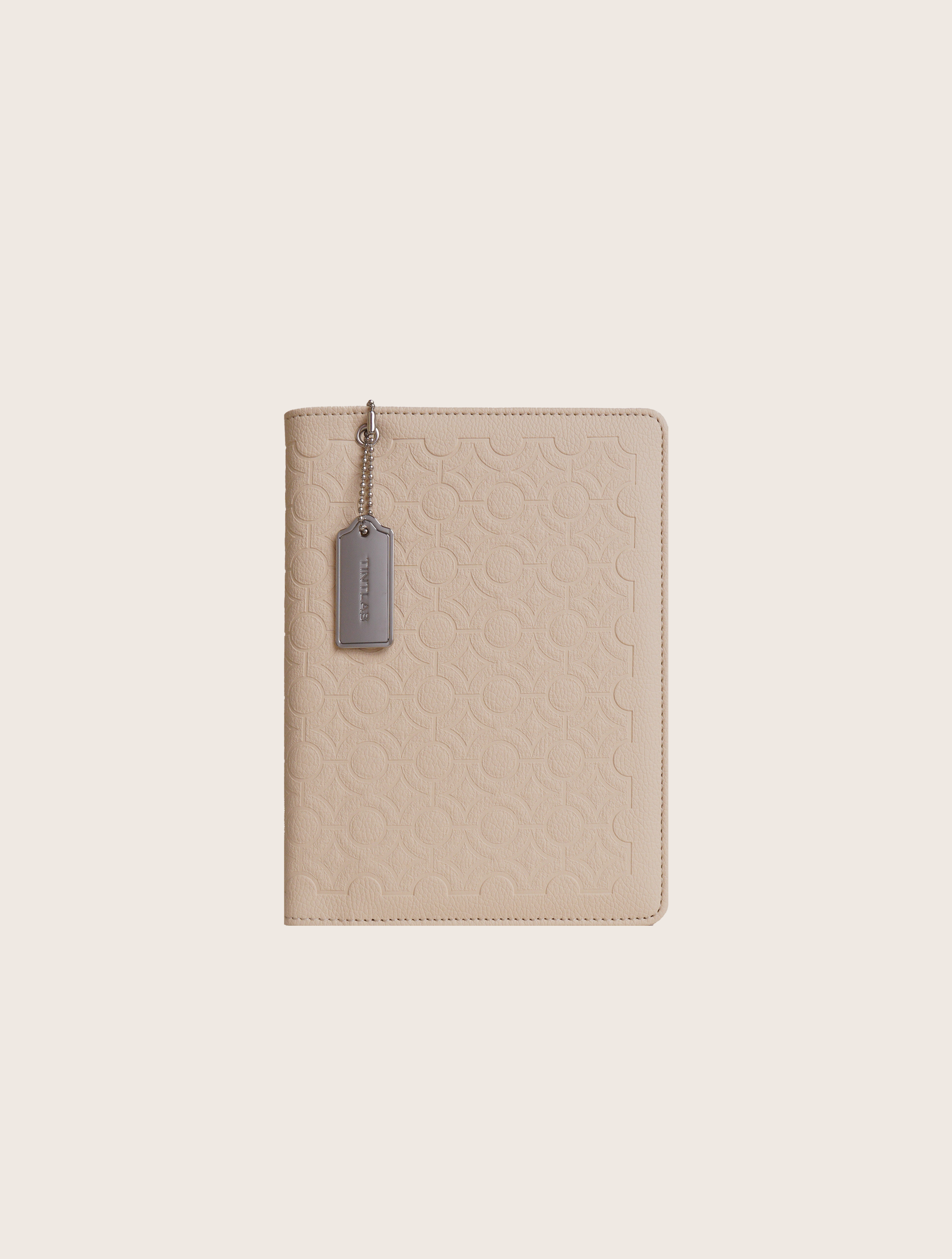 Beige textured leather notebook sleeve and Cover, Quran Sleeve and Cover, embossed geometric pattern and a silver metal logo tag with chain
