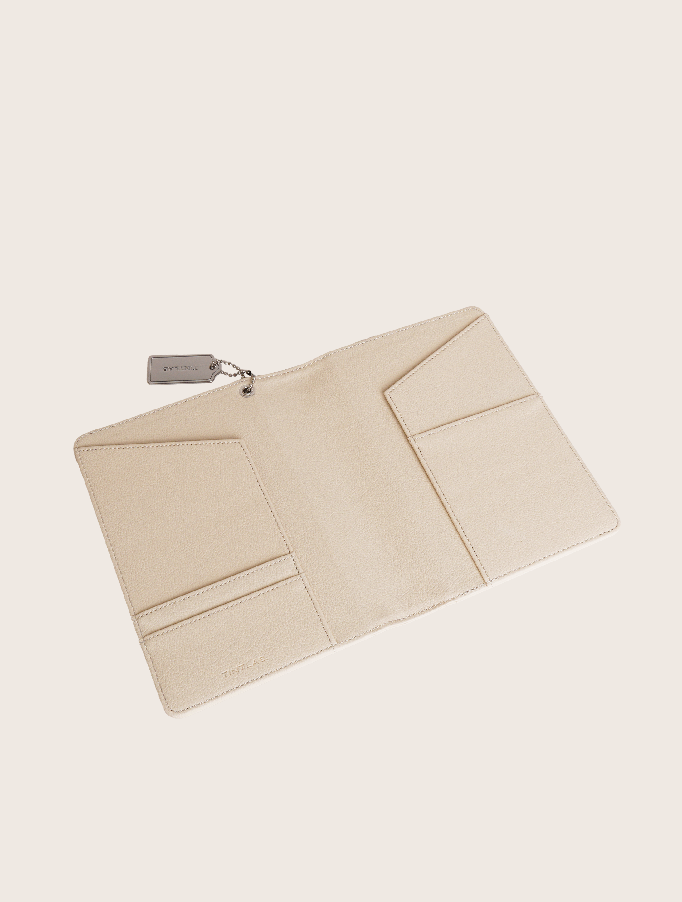 Beige textured leather notebook sleeve and Cover, Quran Sleeve and Cover, embossed geometric pattern and a silver metal logo tag with chain