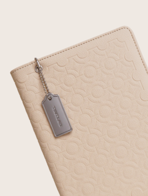 Beige textured leather notebook sleeve and Cover, Quran Sleeve and Cover, embossed geometric pattern and a silver metal logo tag with chain