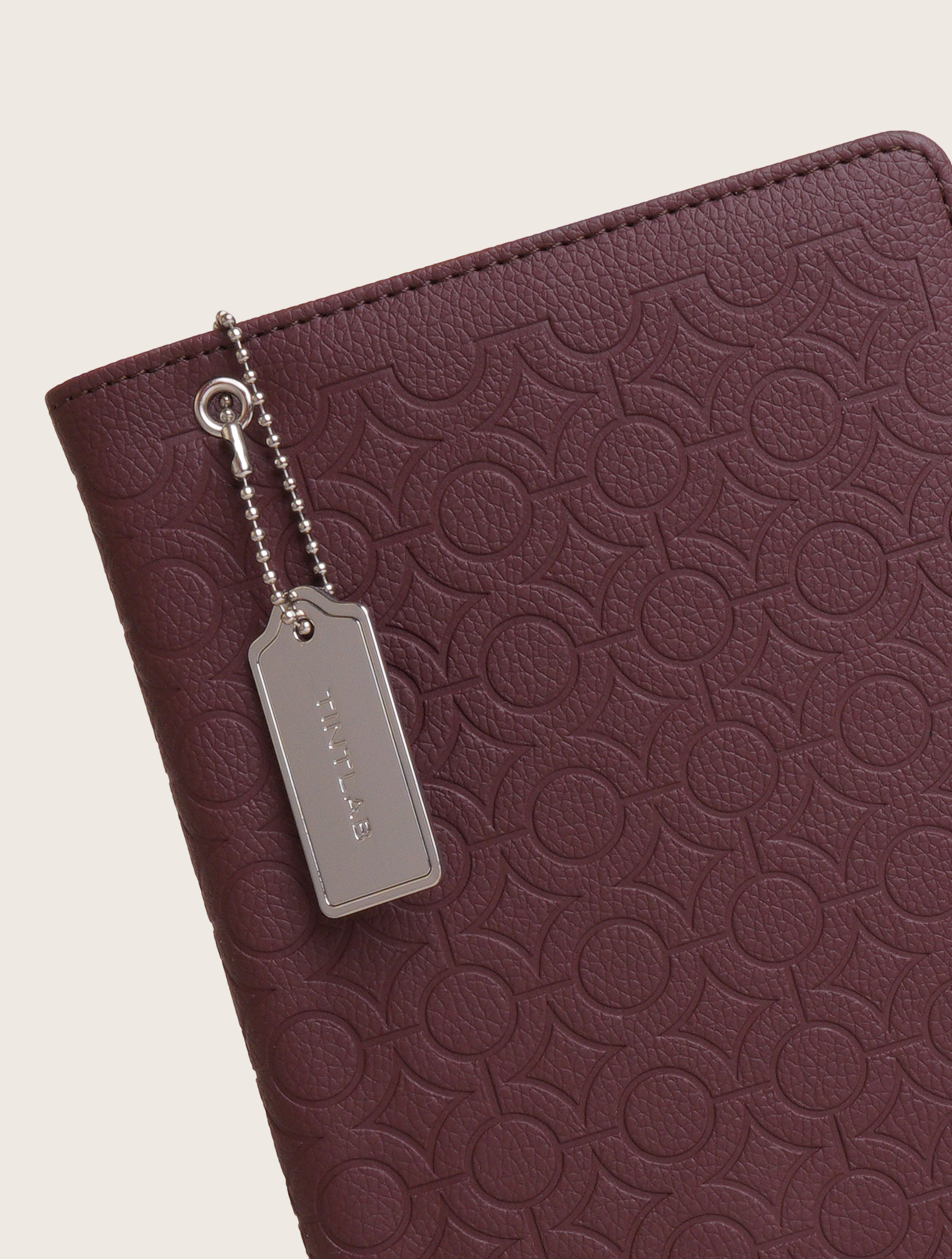Burgundy textured leather notebook sleeve and Cover, Quran Sleeve and Cover, embossed geometric pattern and a silver metal logo tag with chain