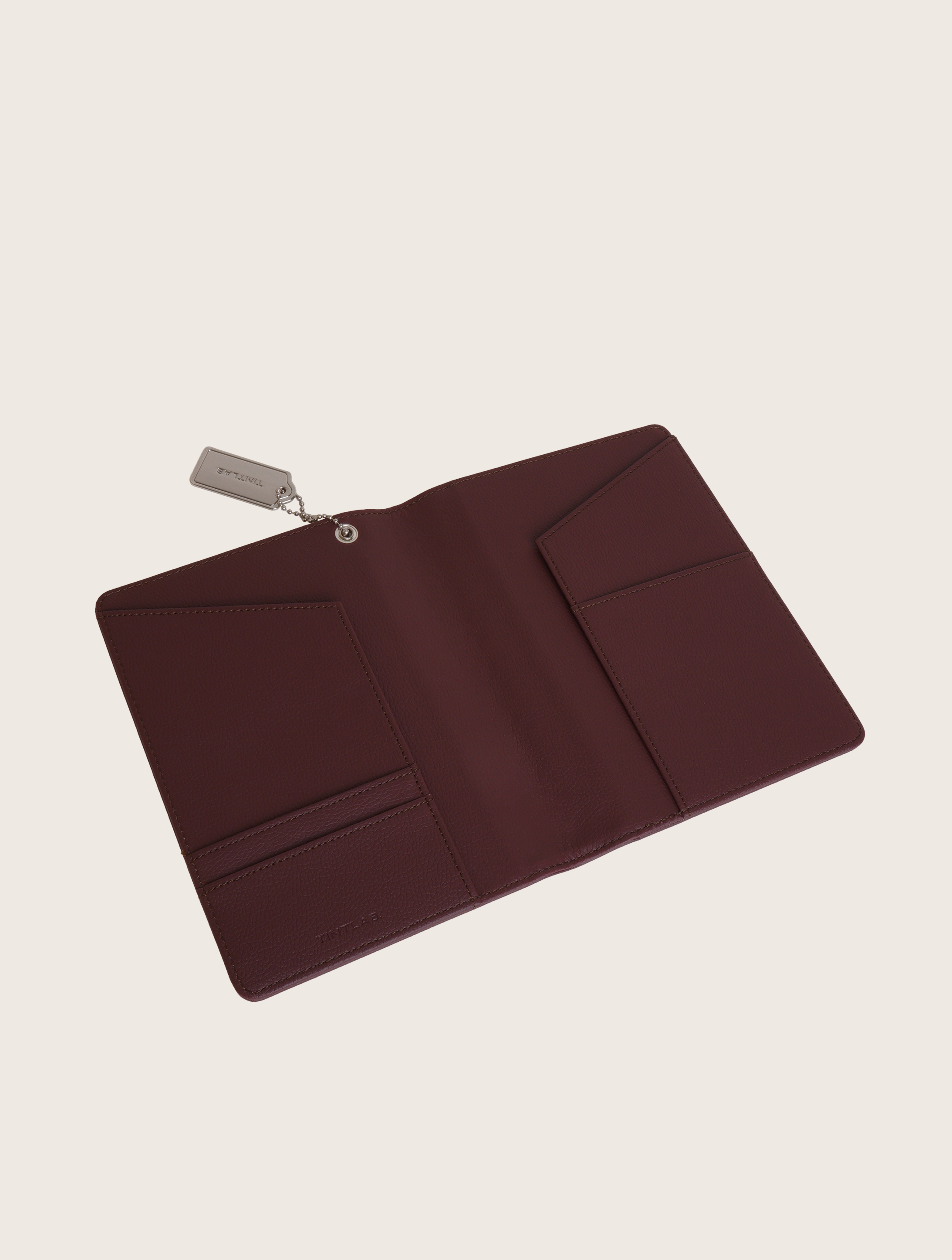 Burgundy textured leather notebook sleeve and Cover, Quran Sleeve and Cover, embossed geometric pattern and a silver metal logo tag with chain